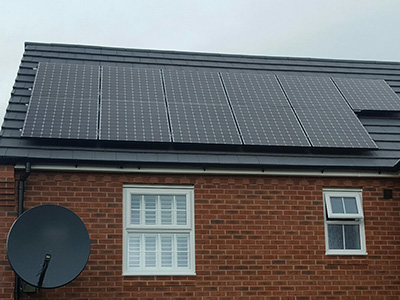 Black panel Solar PV installation on slate roof